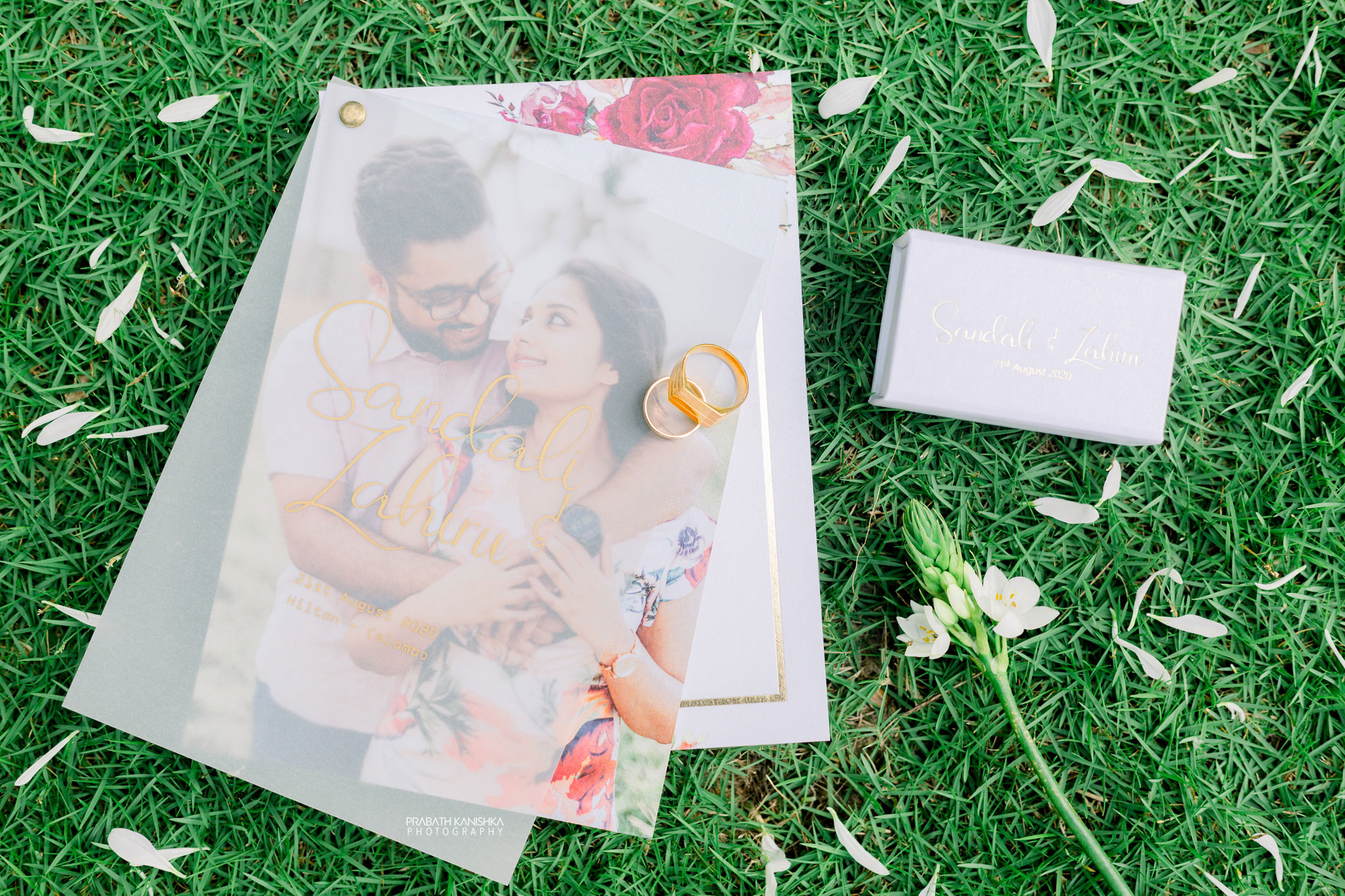 Wedding rings beside an engagement keepsake