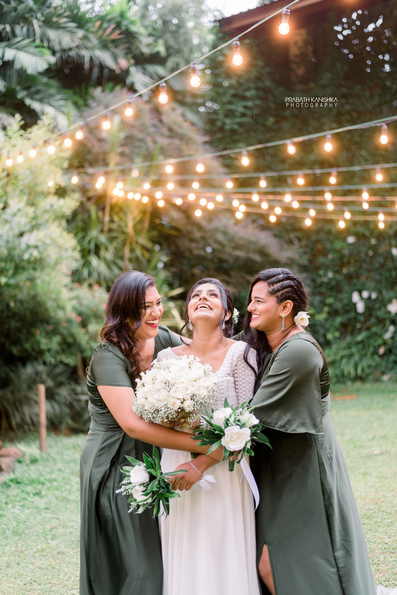 Bride with bridesmaids in a lantern-lit garden