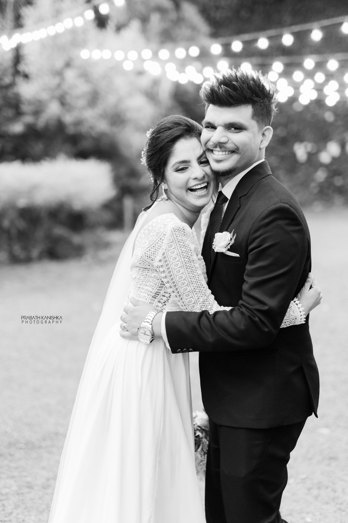 Couple embracing under garden lights